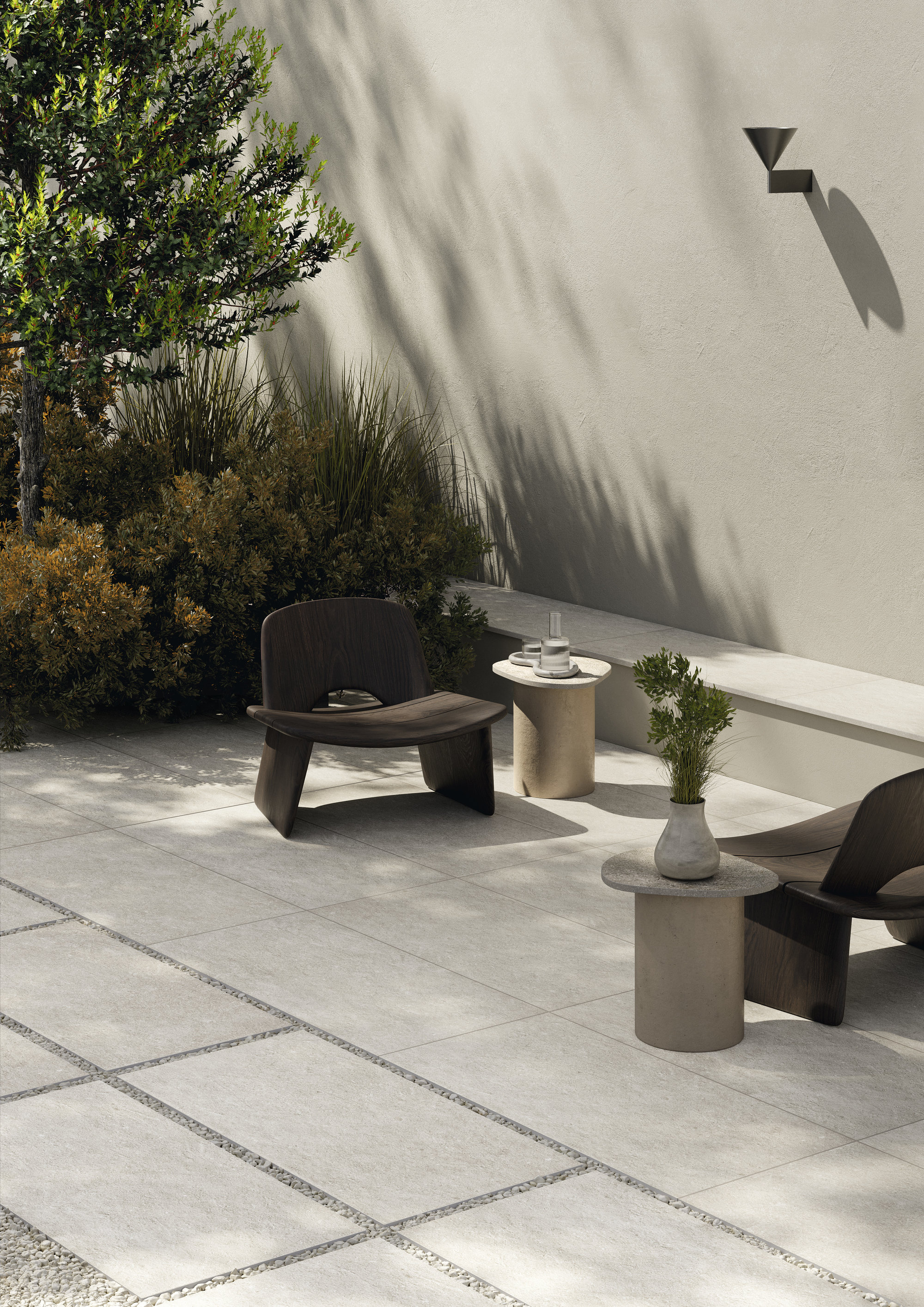 Modern terrace with light outdoor tiles, lounge furniture, and plants.