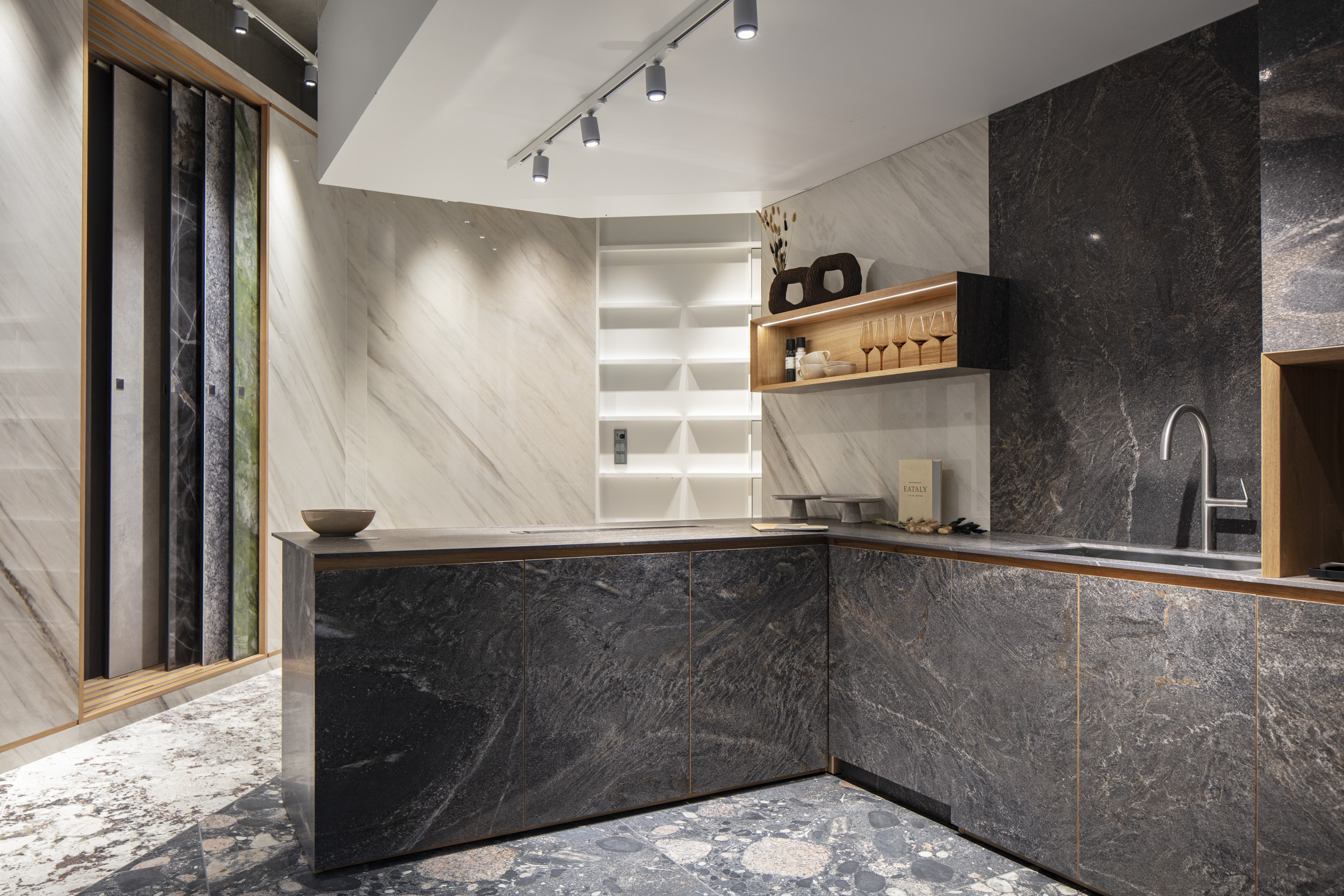 High-quality tiles: dark stone look for kitchens, light marble look for showroom walls.