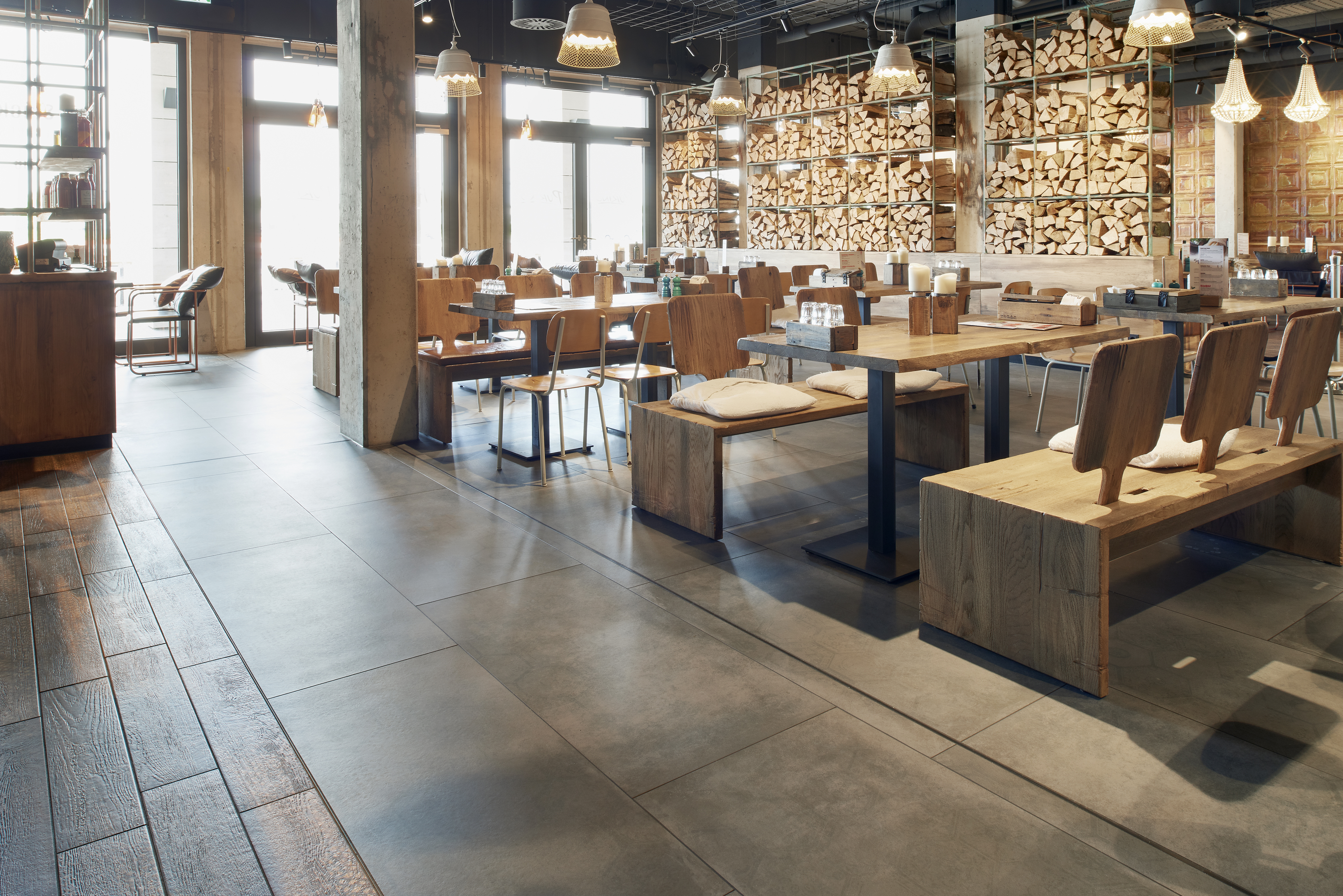 Stylish wood-look and concrete-look floor tiles in a modern interior.