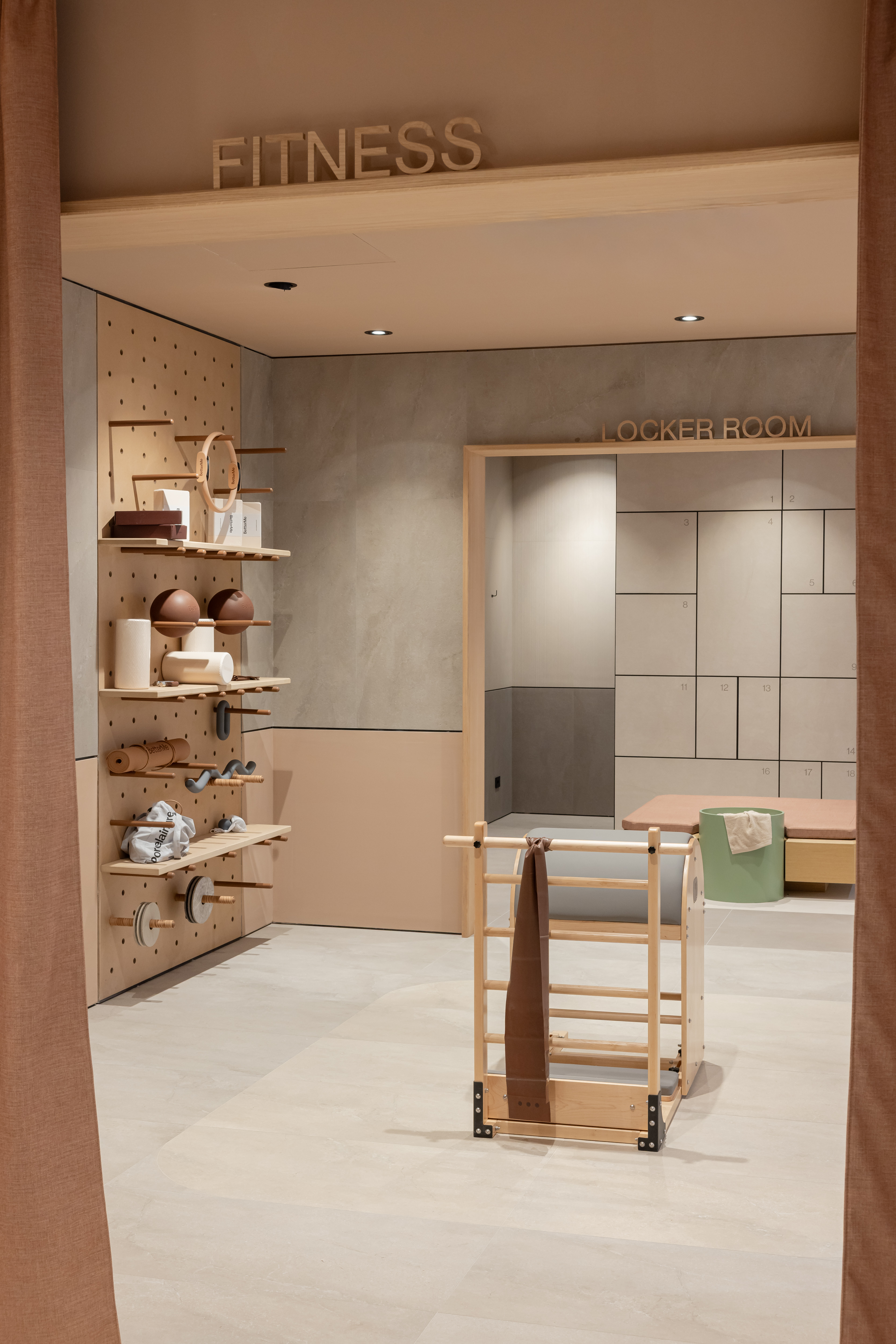 Stylish light beige floor tiles for modern fitness and changing rooms.