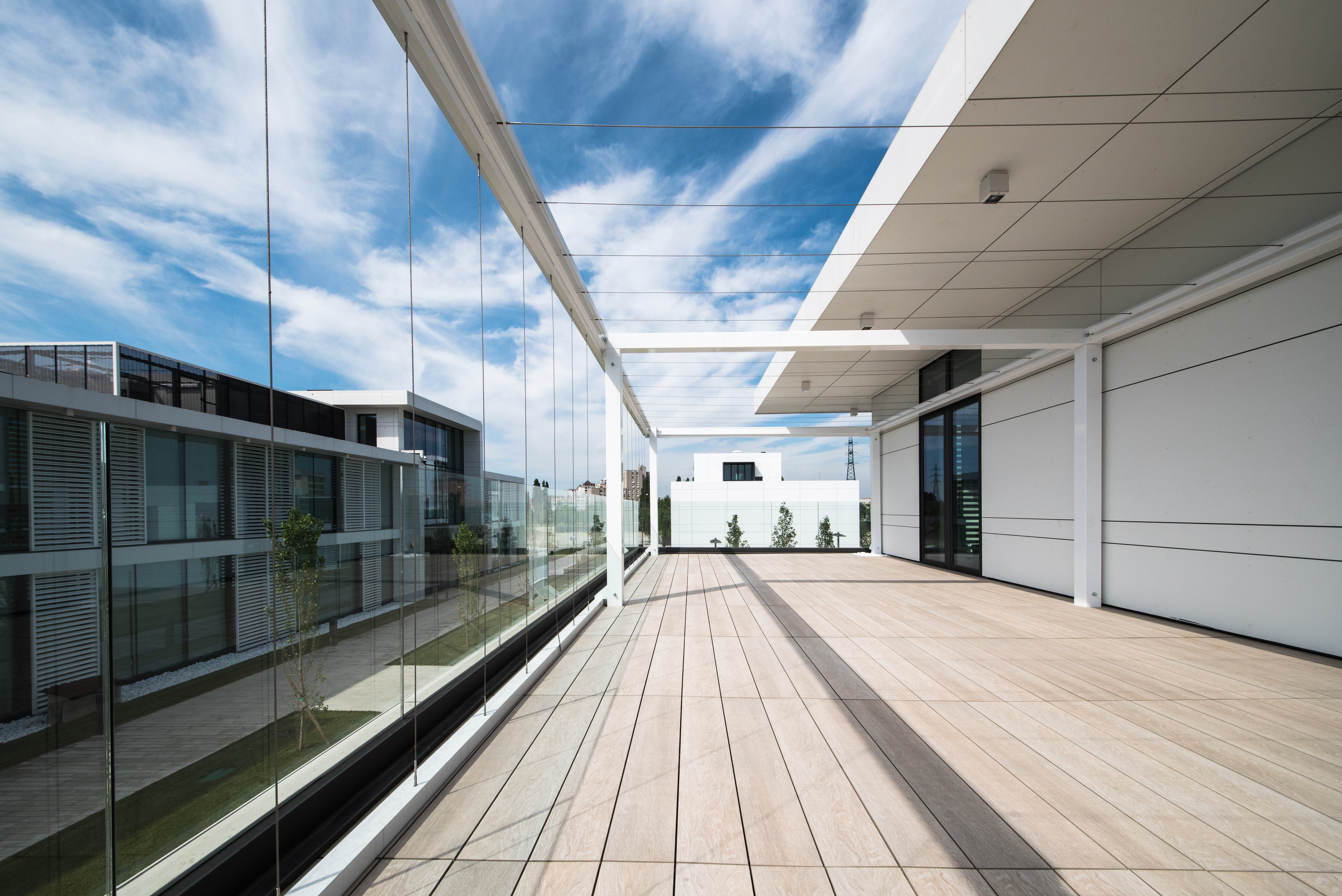 High-quality outdoor tiles in light wood effect on a modern roof terrace.
