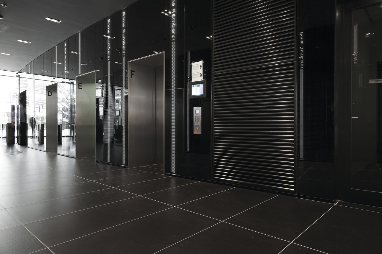High-quality dark large-format tiles in a modern reception hall.