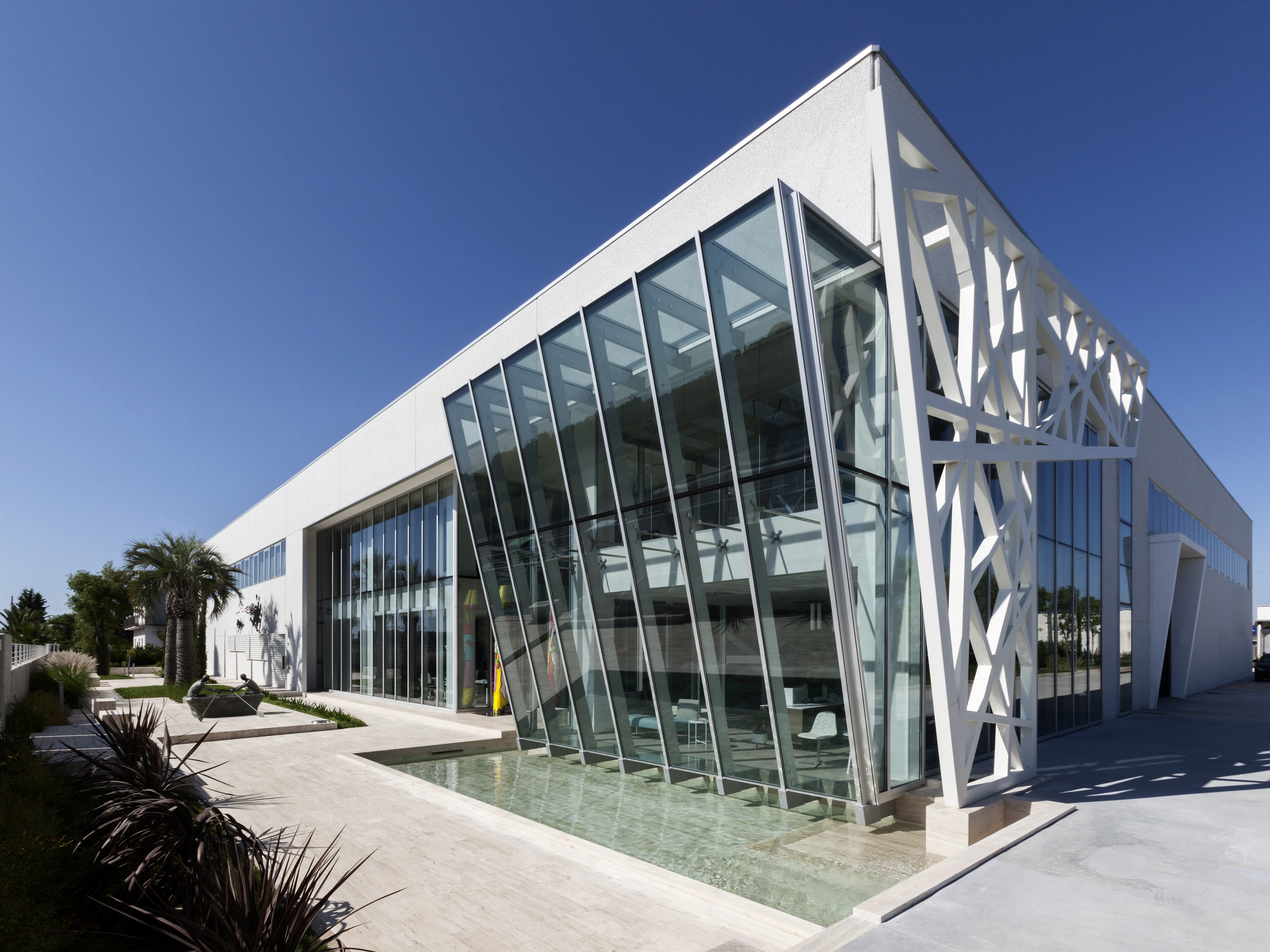 Elegant, modern building with glass front and water, reflecting the style of our tiles.