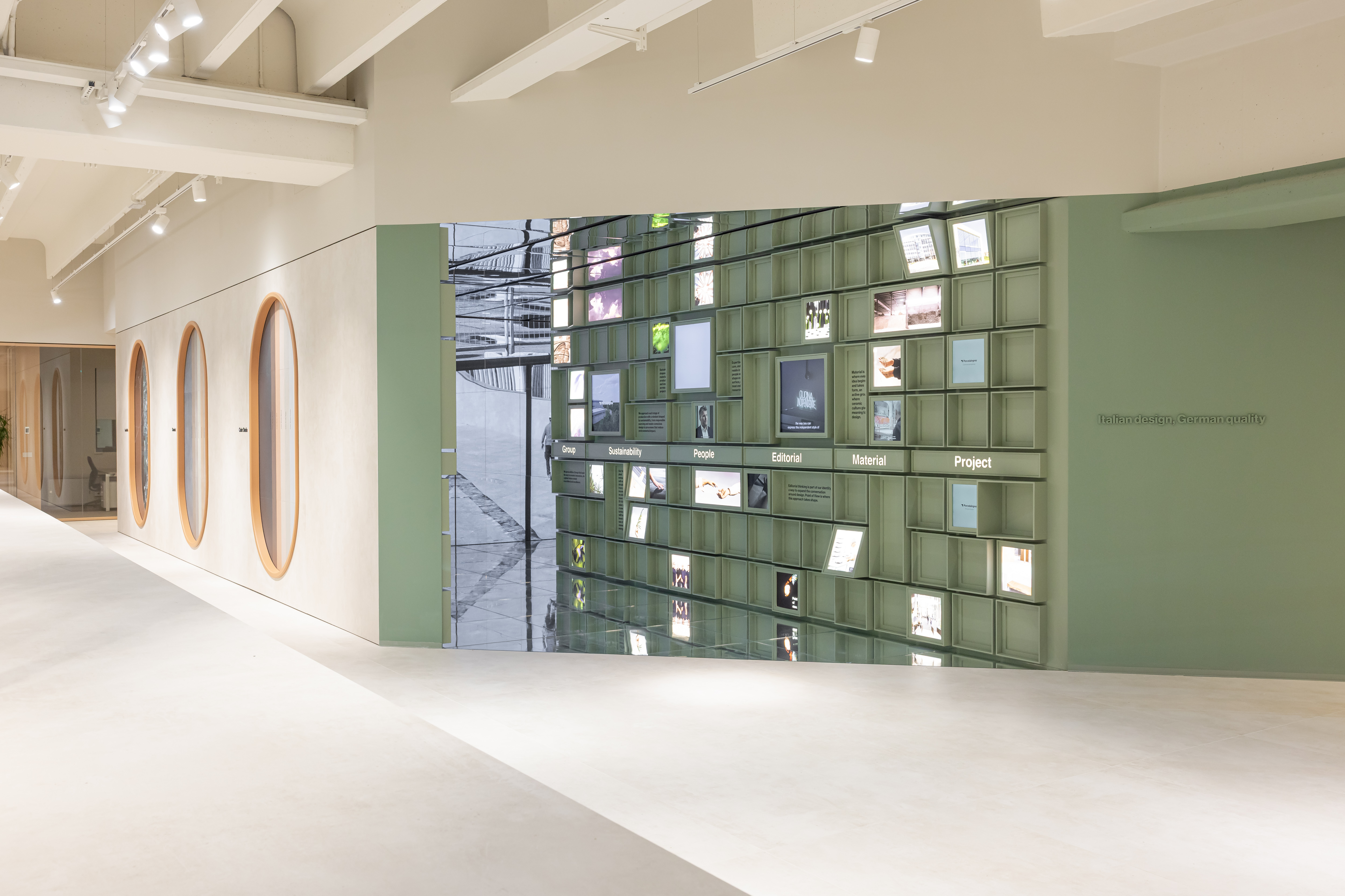 Modern showroom with stylish green display wall for tile inspiration.