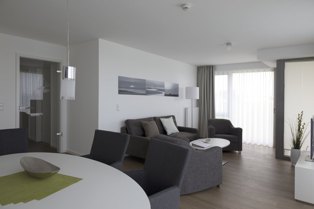 Bright living room with modern tiles in warm wood look.