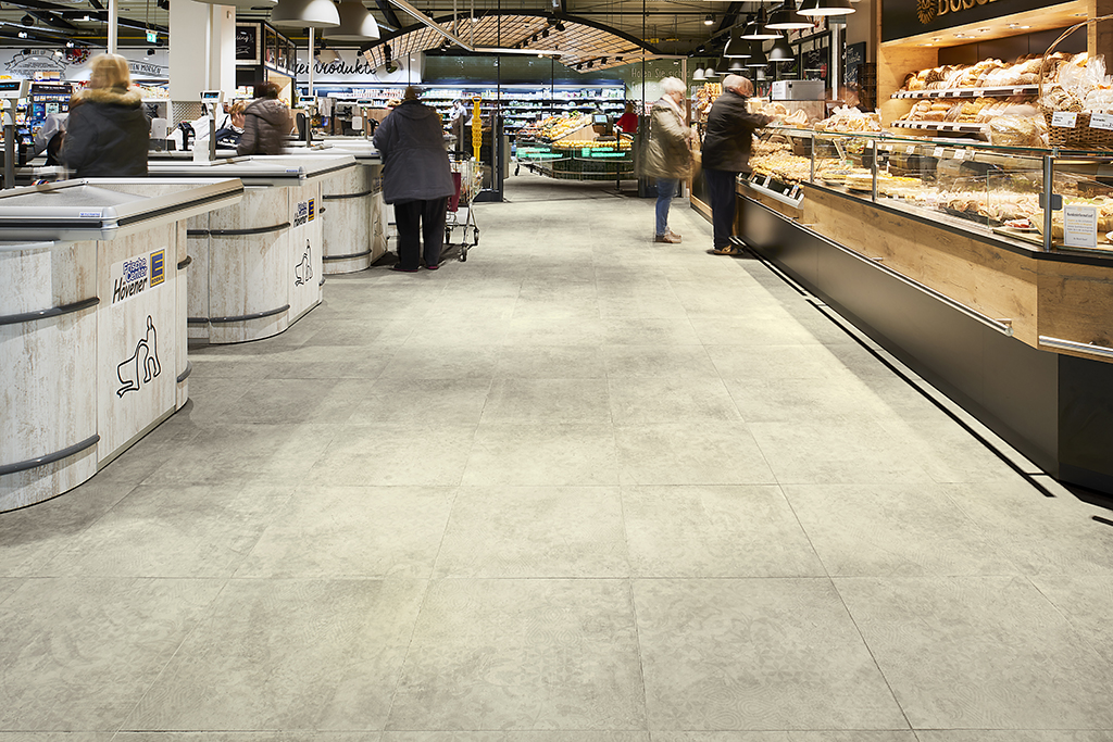 Durable, light grey tiles for commercial interiors, ideal for supermarkets.