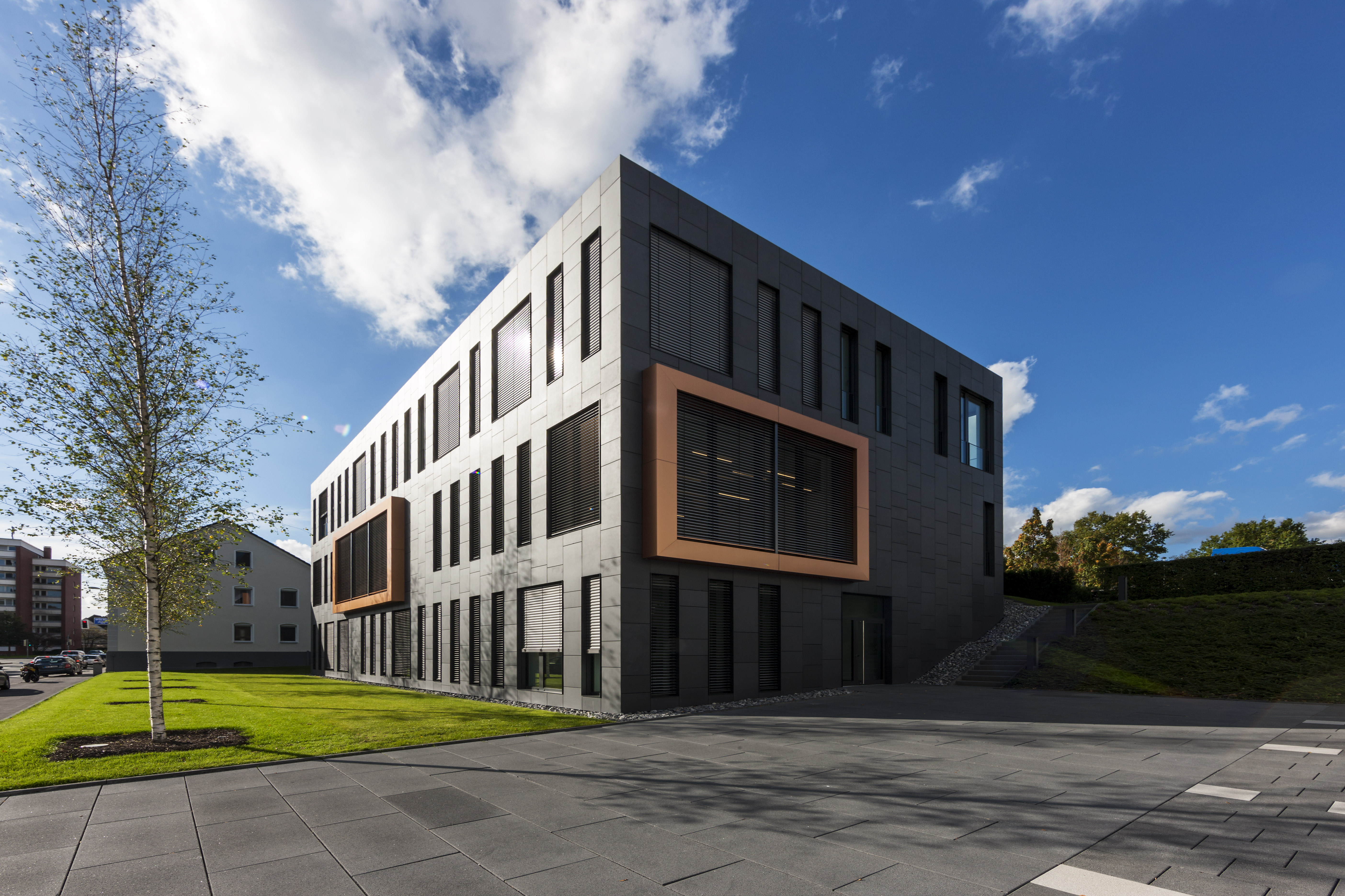 Large-format Porcelaingres outdoor tiles in front of a modern building.