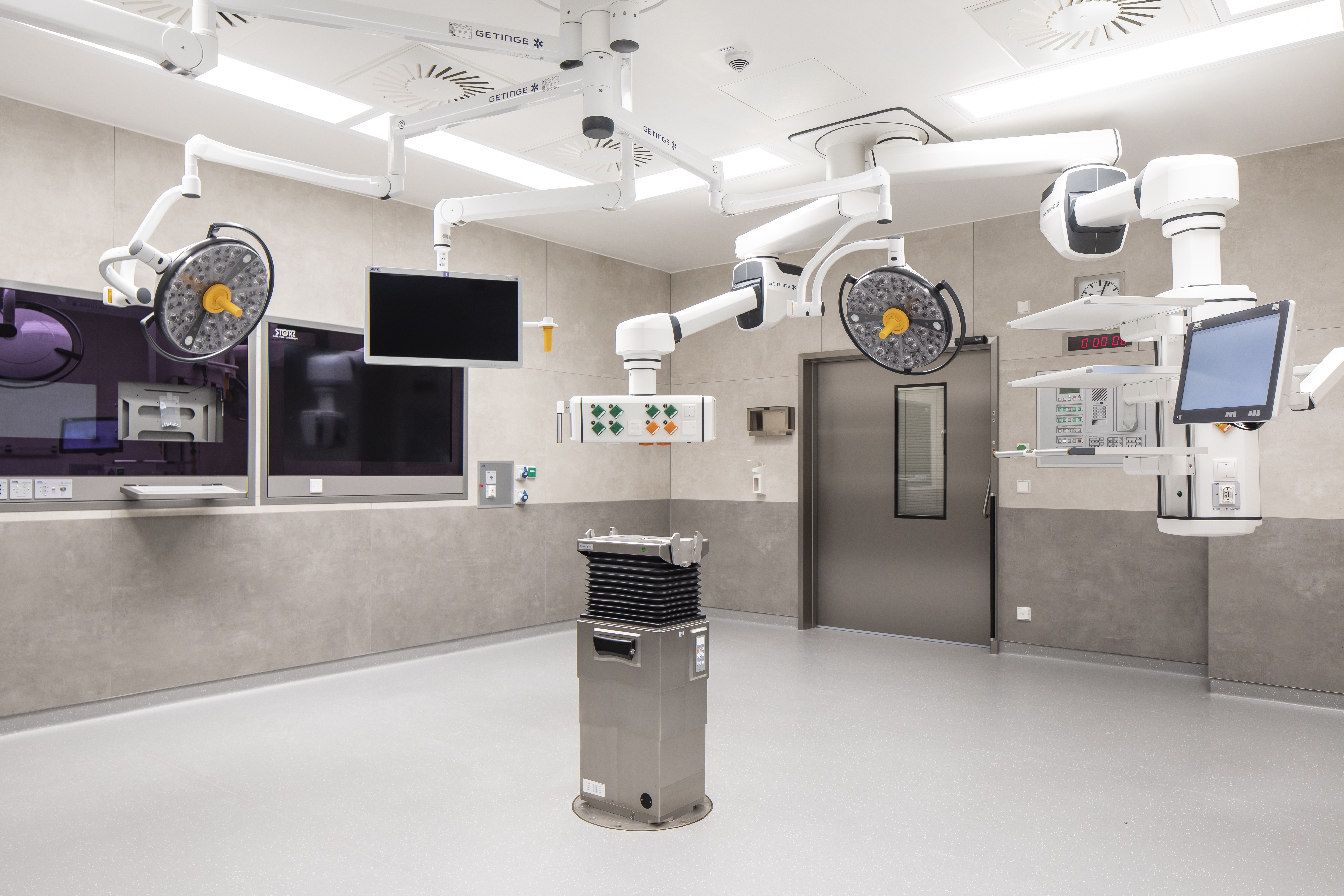 Modern operating room with bright, large-format wall and floor surfaces.