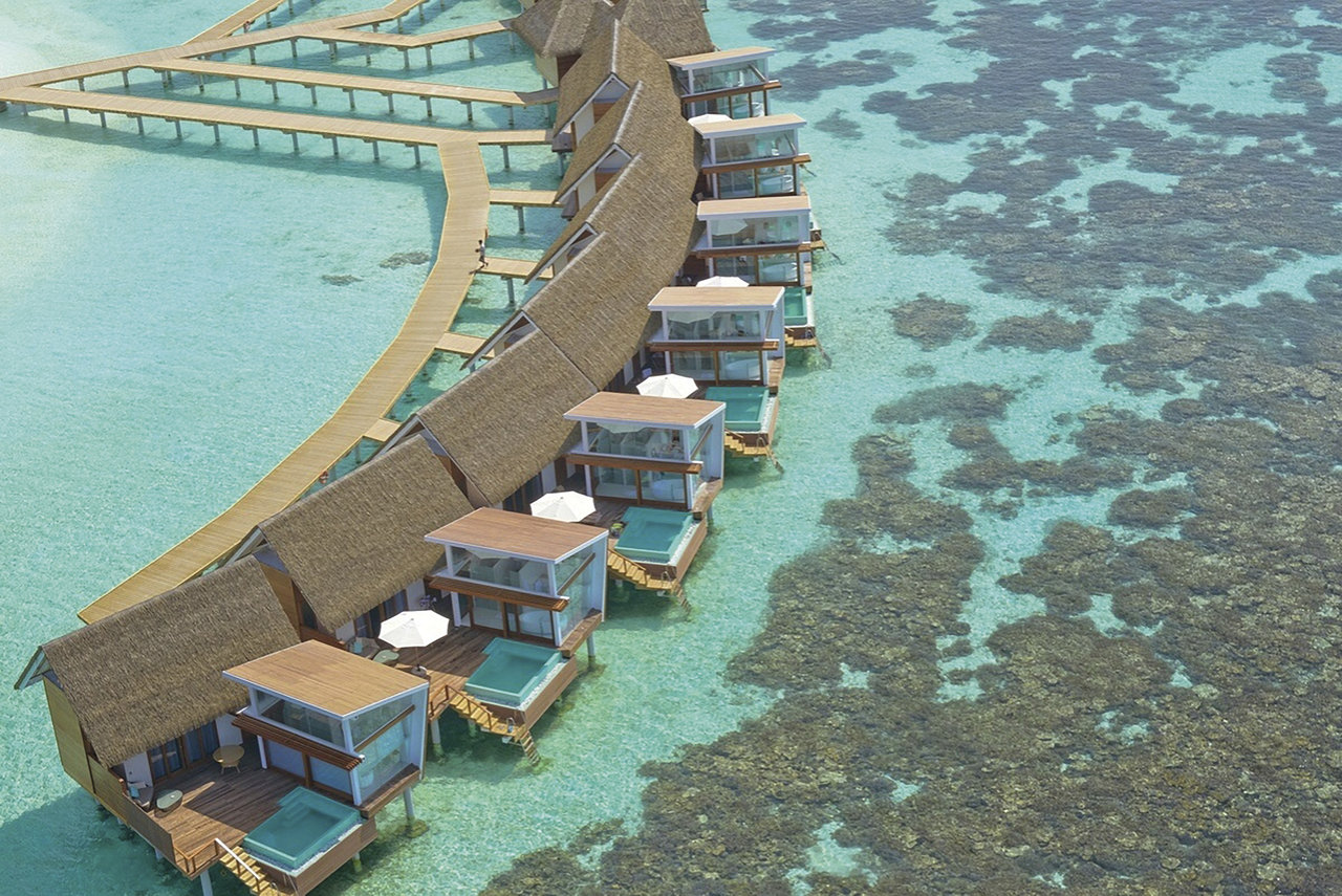 Aerial view of a luxurious overwater resort, inspiring stylish outdoor tile ideas.