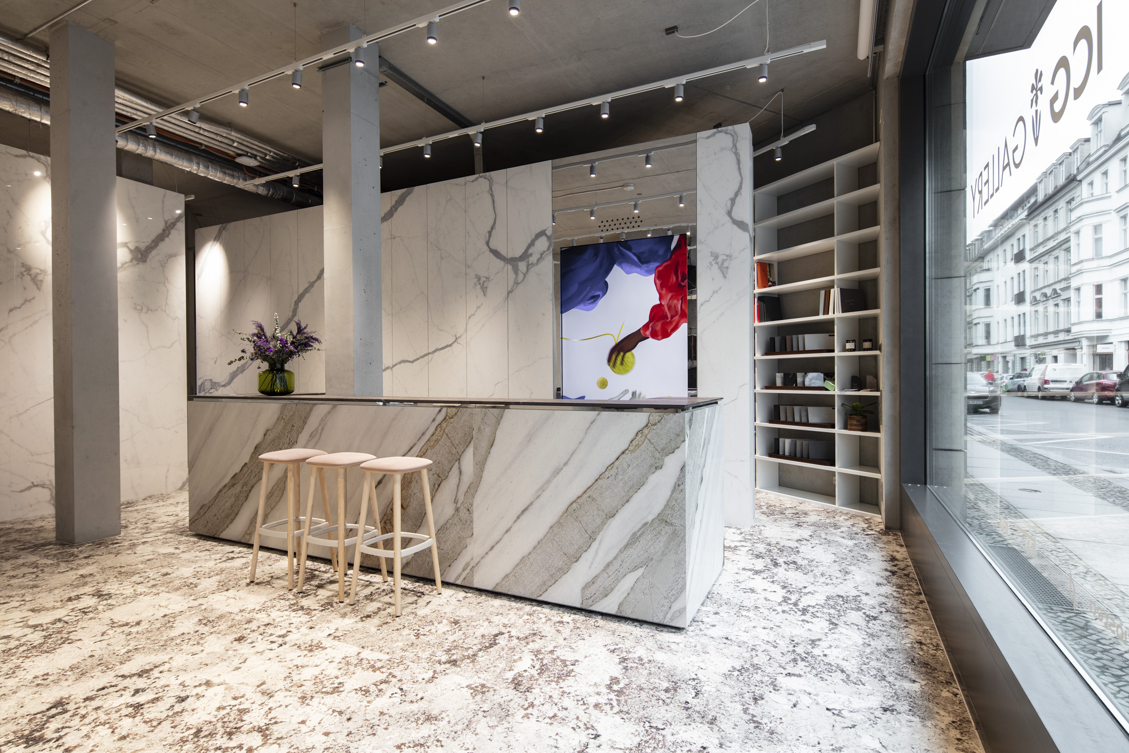 Tile showroom ideas: Marble-look wall tiles, textured floor tiles, elegant counter.