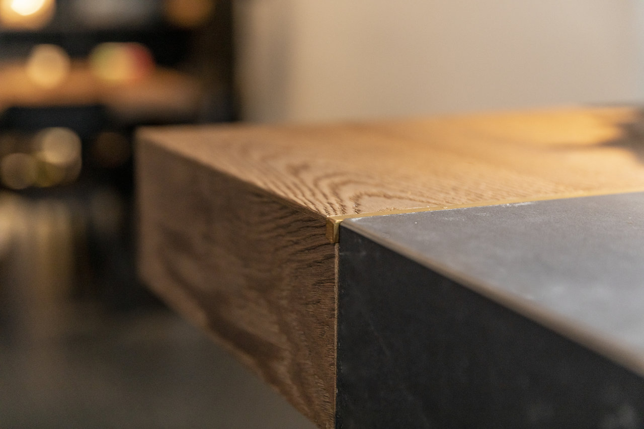 Material mix: Wood and dark concrete-effect tile in detail.