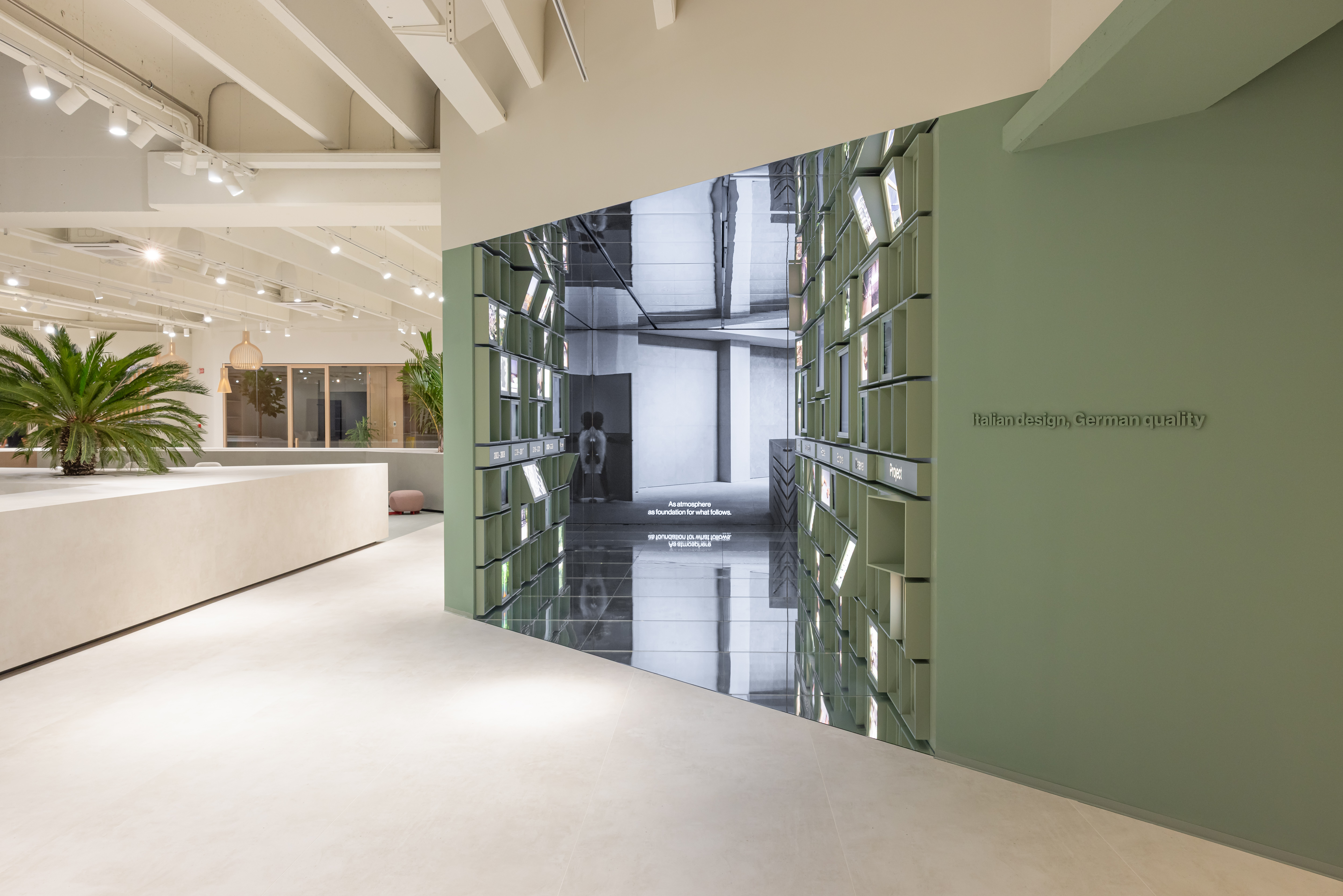 Elegant tile showroom, bright floor, modern mirror feature.