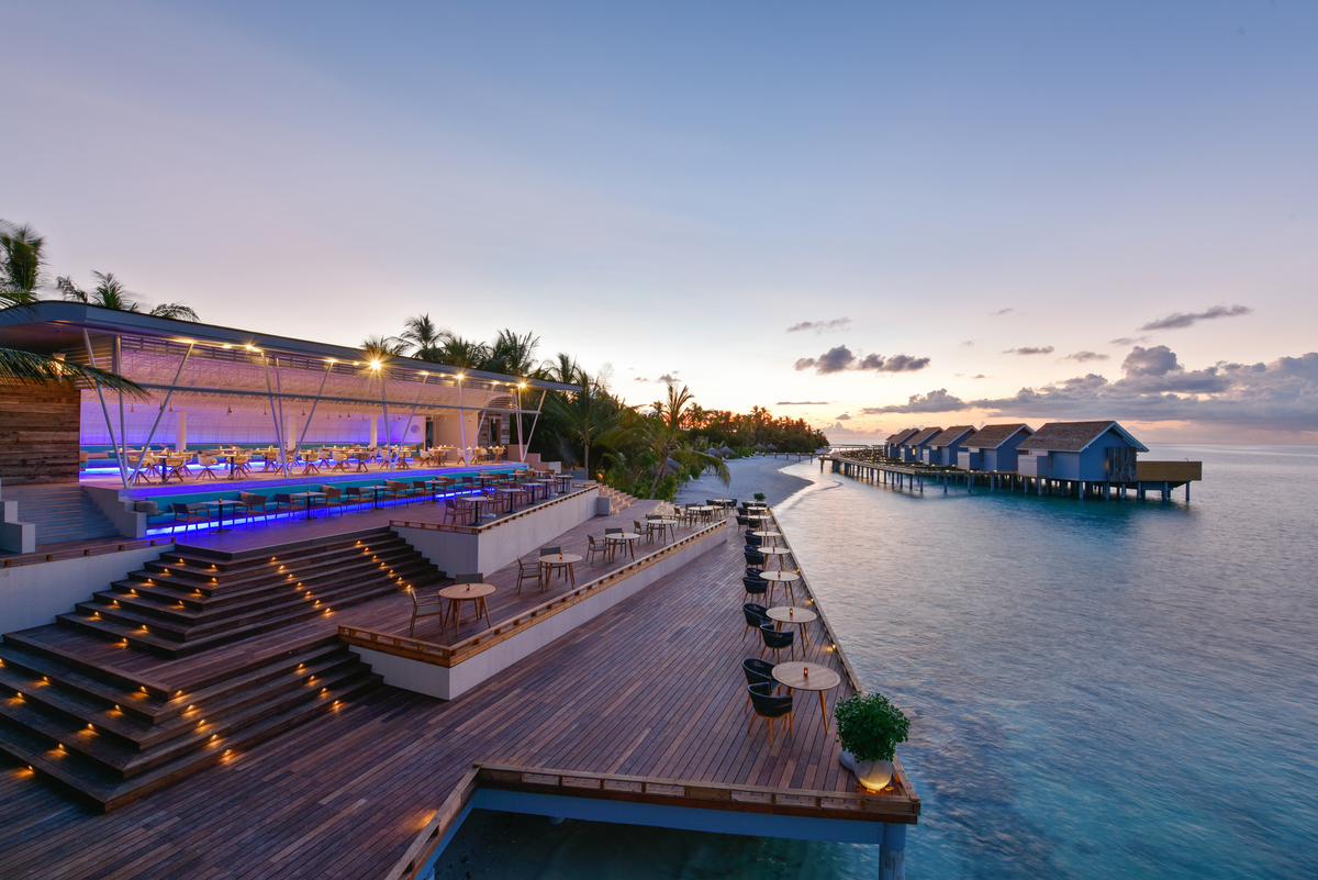 Stylish outdoor design with wooden deck and sea view at dusk – perfect for tiles.